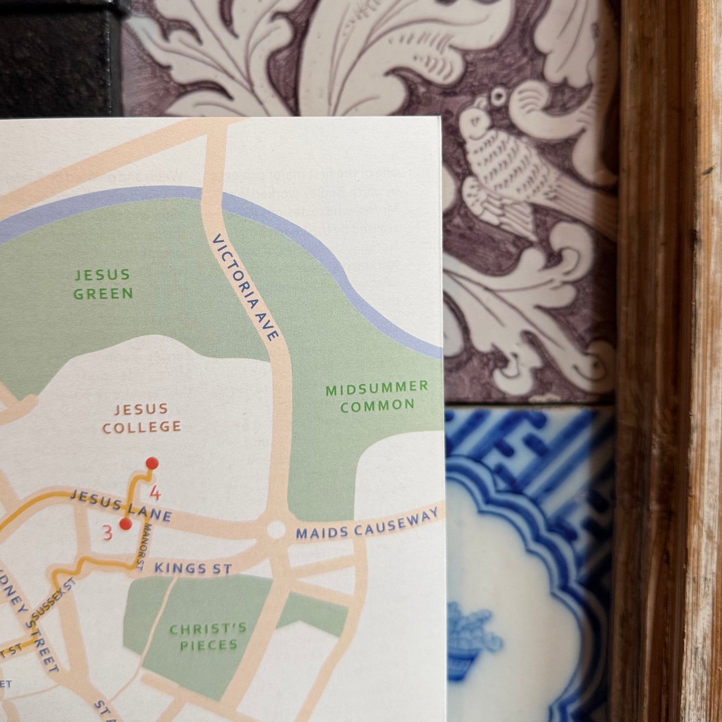 Map of a city street layout with decorative tiles in the background