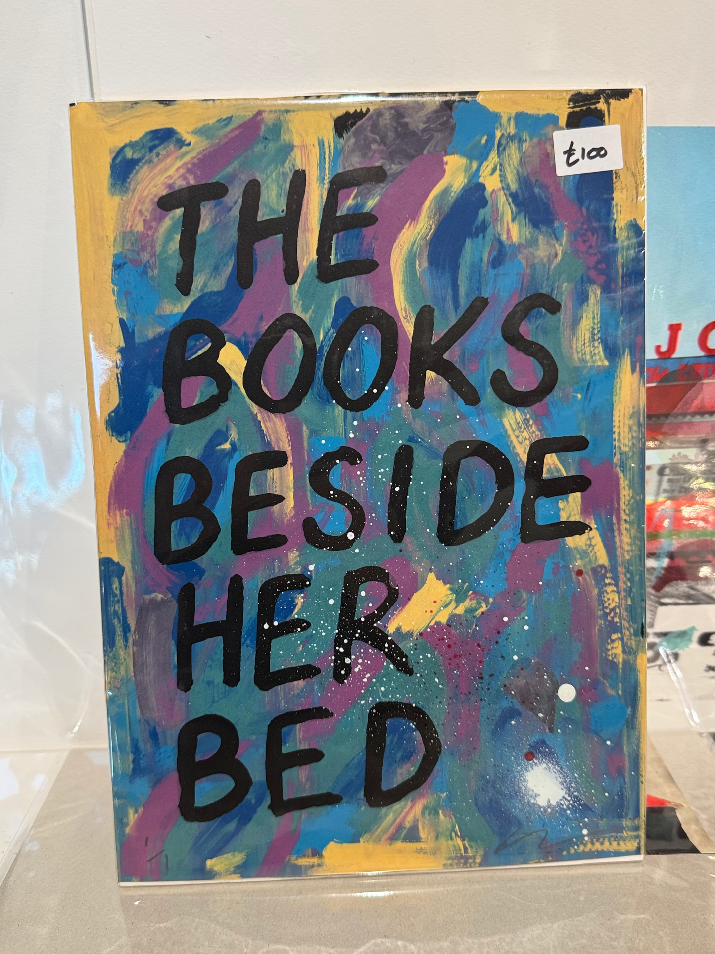 Colorful abstract painting with text on a white surface