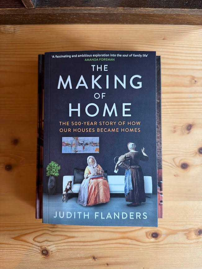 Book titled 'The Making of Home' by Judith Flanders on a wooden surface