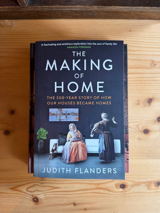 Book titled 'The Making of Home' by Judith Flanders on a wooden surface